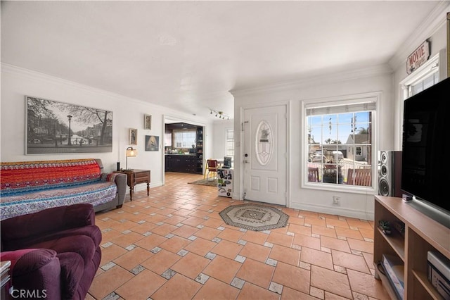 foyer featuring baseboards and ornamental molding