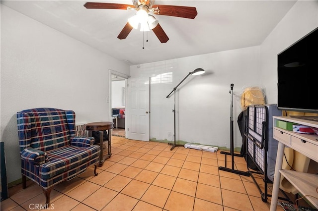 living area featuring light tile patterned flooring and a ceiling fan