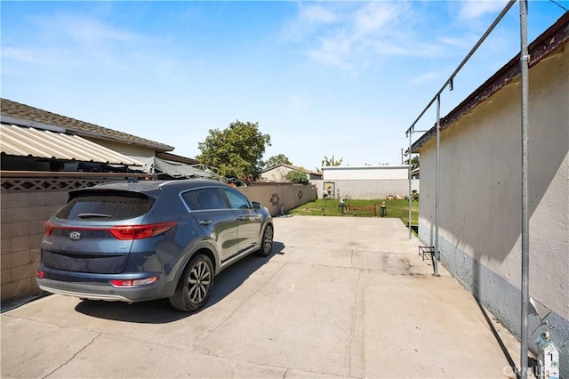 exterior space with driveway and fence