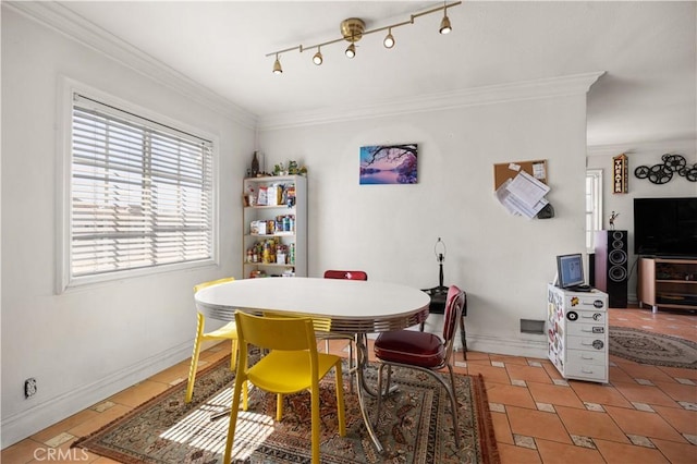 dining space featuring light tile patterned flooring, baseboards, ornamental molding, and rail lighting