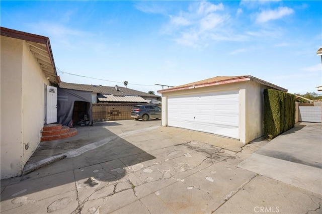 detached garage featuring fence