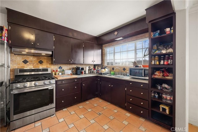 kitchen featuring under cabinet range hood, a sink, backsplash, appliances with stainless steel finishes, and light countertops