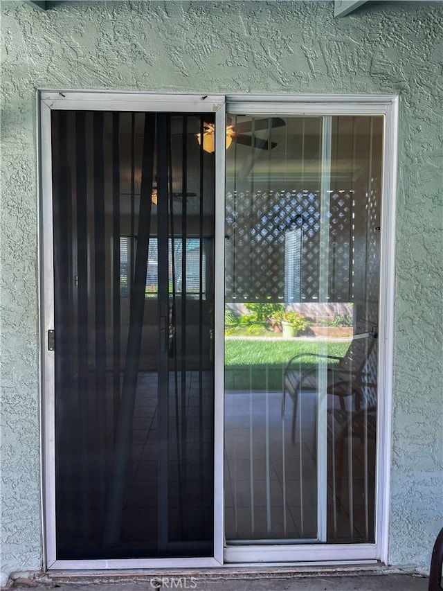 property entrance featuring stucco siding