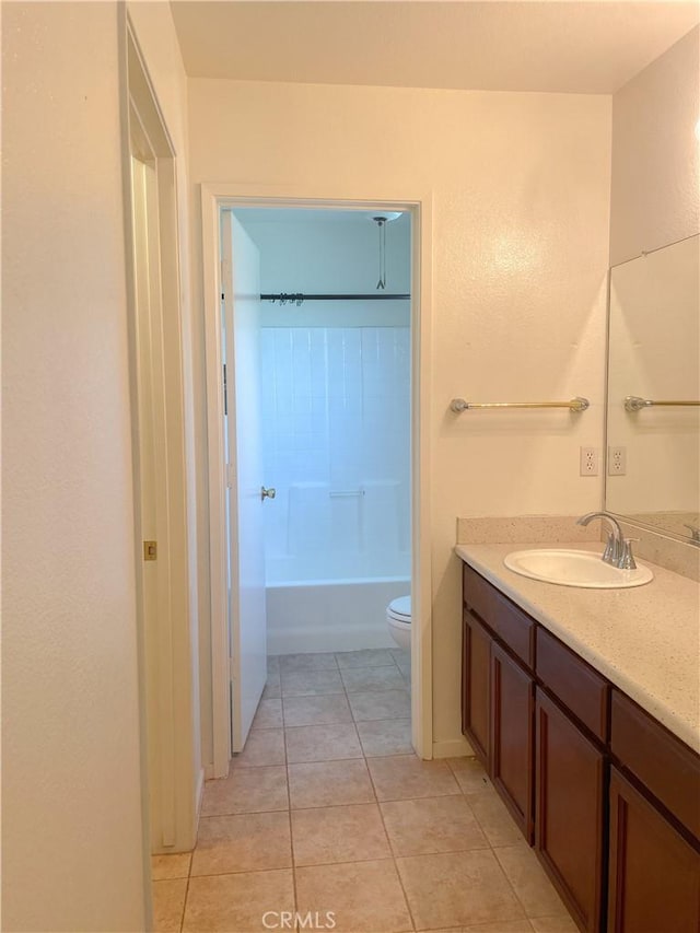 full bathroom with toilet, tile patterned flooring, a bathtub, and vanity