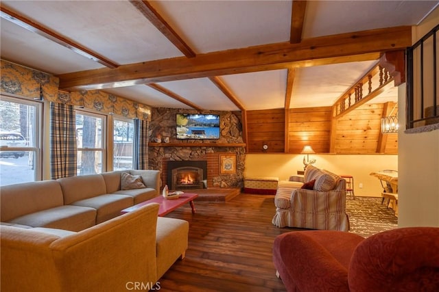 living room featuring beam ceiling, a fireplace, and dark wood-style flooring