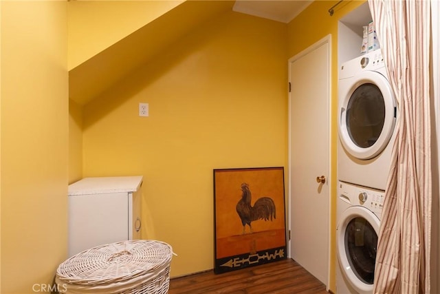 clothes washing area with laundry area, stacked washer and clothes dryer, and dark wood-style flooring