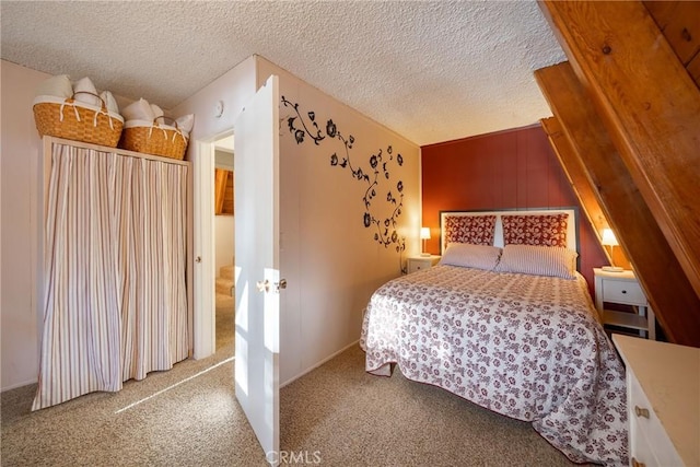 bedroom with a textured ceiling and carpet floors