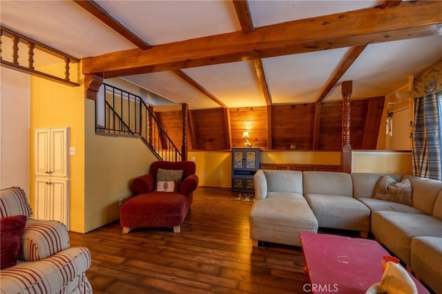 living area with wood-type flooring, beam ceiling, and stairs