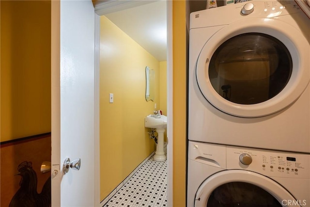 clothes washing area with laundry area and stacked washer and dryer