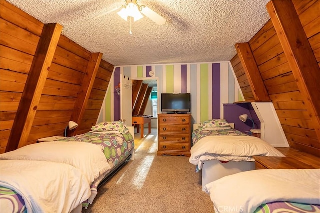 bedroom with a textured ceiling, a ceiling fan, and wallpapered walls