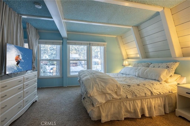 carpeted bedroom with beamed ceiling, multiple windows, and a textured ceiling