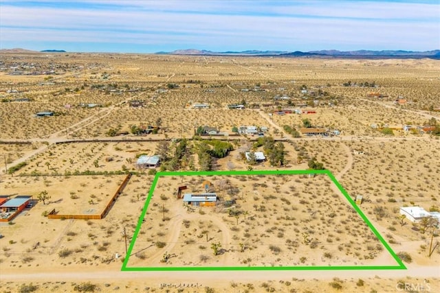 drone / aerial view with a rural view, a mountain view, and view of desert