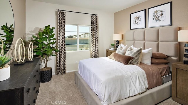 carpeted bedroom featuring baseboards