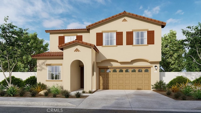 mediterranean / spanish home with an attached garage, fence, driveway, a tiled roof, and stucco siding