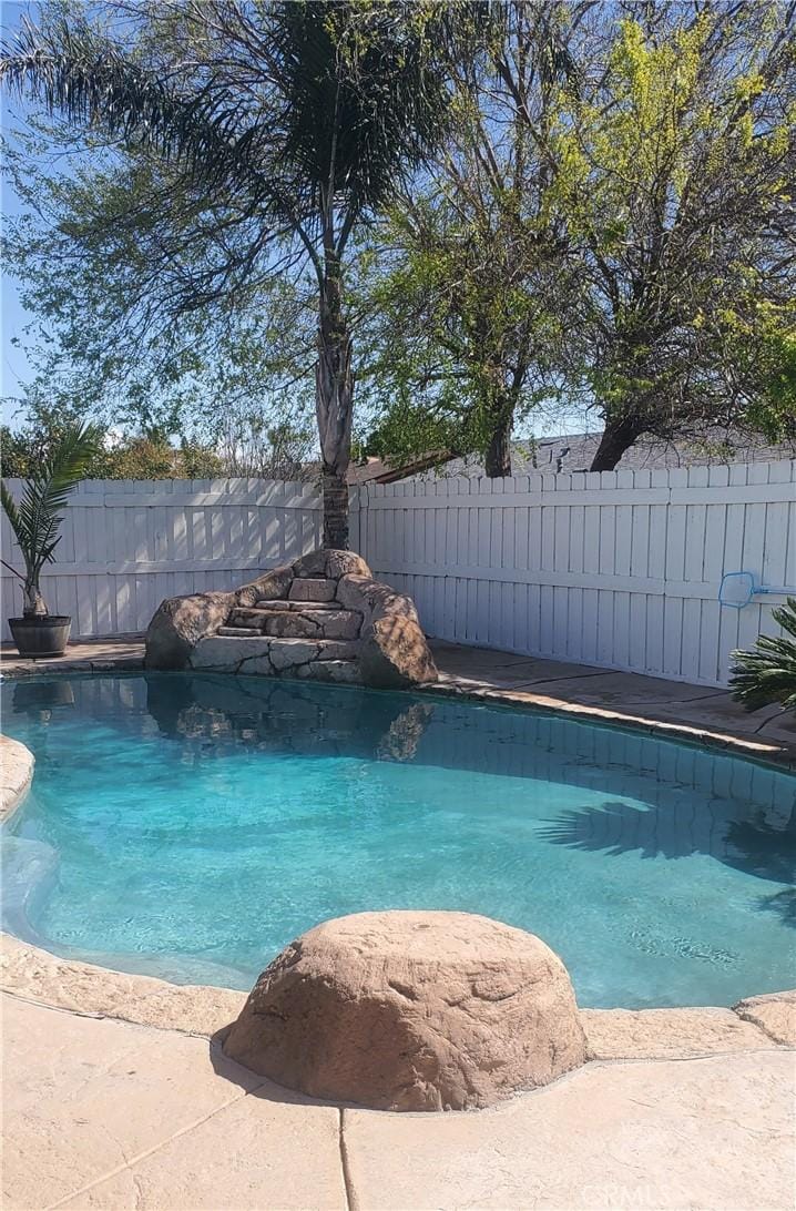 view of swimming pool featuring fence and a fenced in pool