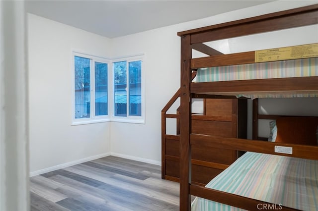 unfurnished bedroom featuring baseboards and wood finished floors