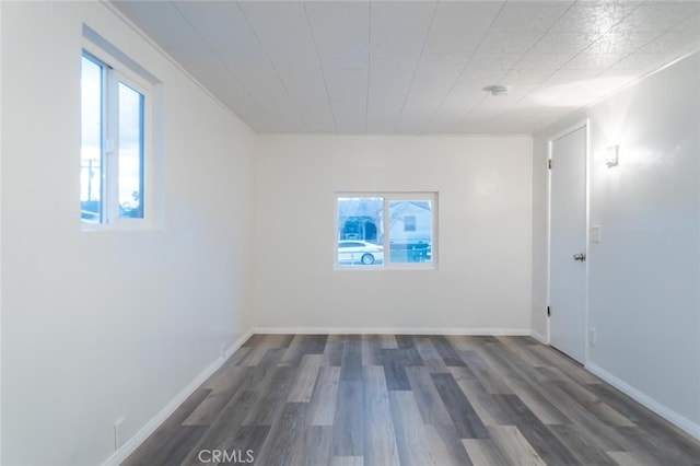 below grade area featuring wood finished floors and baseboards