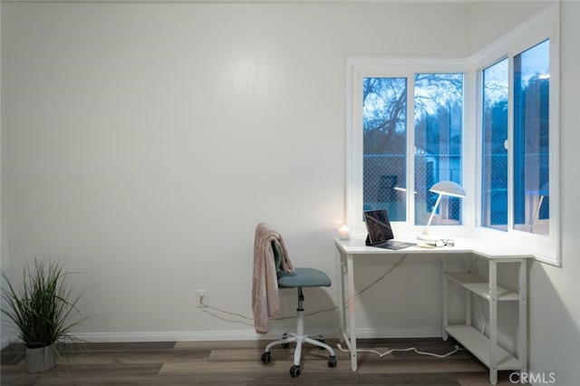 home office featuring baseboards and wood finished floors