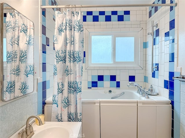 bathroom with a sink, curtained shower, tile walls, and a bath