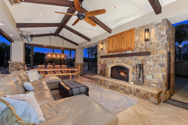 living room featuring recessed lighting, vaulted ceiling with beams, an outdoor stone fireplace, and ceiling fan