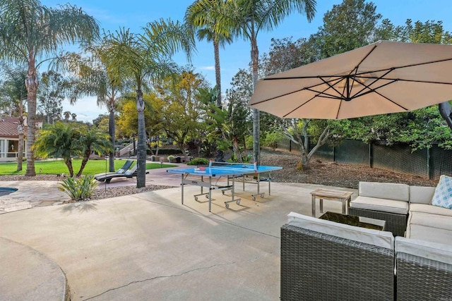 view of patio with outdoor lounge area and fence