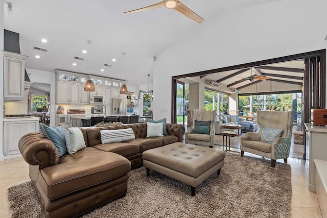 living room with light tile patterned floors, visible vents, plenty of natural light, and a ceiling fan