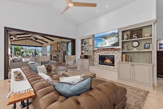 living room featuring high vaulted ceiling, light tile patterned flooring, ceiling fan, a glass covered fireplace, and beamed ceiling