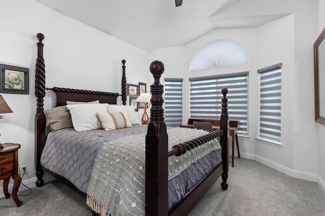 carpeted bedroom featuring baseboards and vaulted ceiling