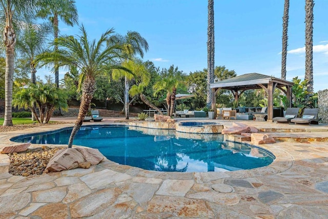 view of pool with a gazebo, a patio, and a pool with connected hot tub