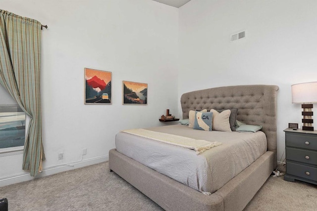 bedroom with light colored carpet, visible vents, and baseboards