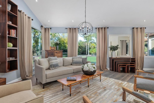 living area with a wealth of natural light, recessed lighting, light wood-style flooring, and vaulted ceiling