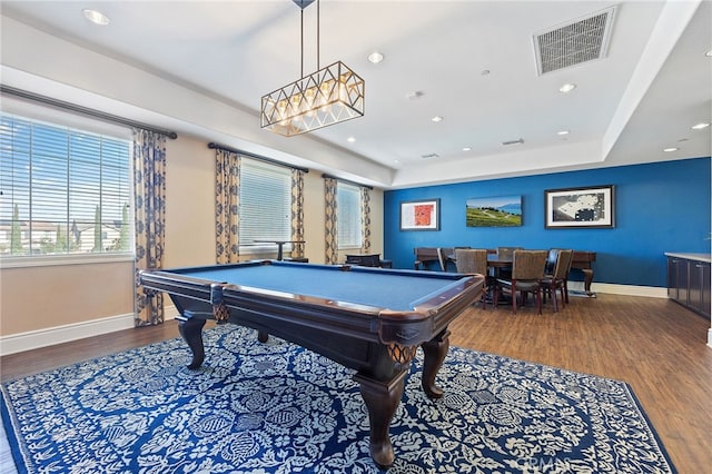 game room with wood finished floors, visible vents, baseboards, a tray ceiling, and recessed lighting