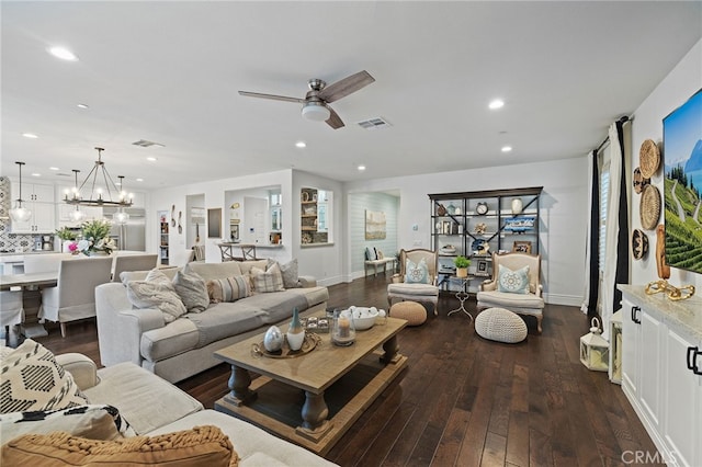 living room with dark wood-style floors, visible vents, recessed lighting, and ceiling fan with notable chandelier