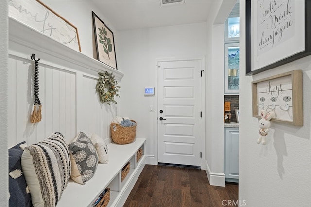 mudroom featuring baseboards and dark wood-style flooring