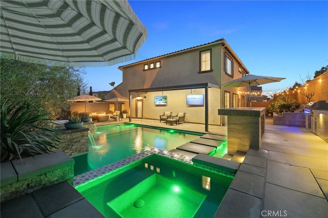 view of pool with an outdoor living space, a pool with connected hot tub, fence, area for grilling, and a patio