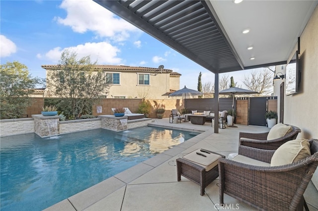 view of pool with outdoor lounge area, a patio area, a fenced in pool, and a fenced backyard