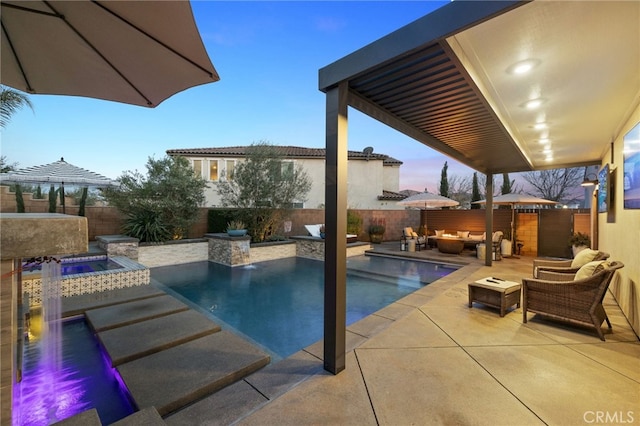 view of swimming pool featuring an in ground hot tub, a fenced in pool, an outdoor living space with a fire pit, and a fenced backyard