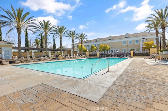 community pool featuring a patio and fence