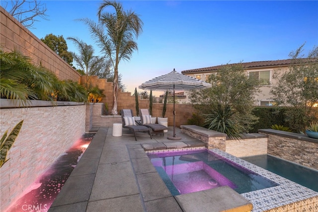 view of pool with a patio, an in ground hot tub, and a fenced backyard