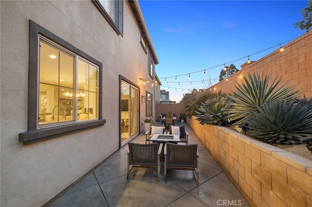 view of patio / terrace with fence and an outdoor fire pit