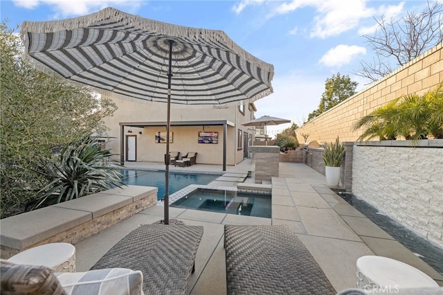 view of swimming pool with a patio, a fenced backyard, and a pool with connected hot tub