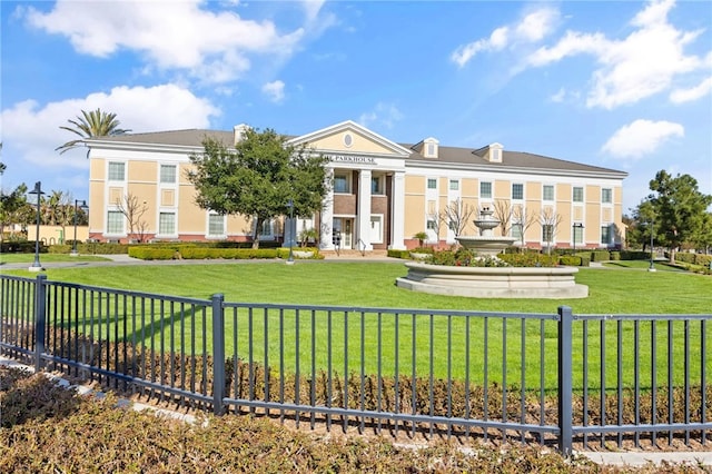 view of front of house featuring a front lawn and fence