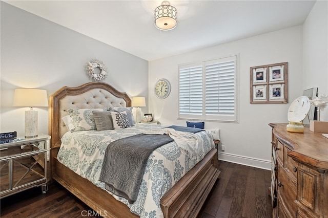 bedroom featuring baseboards and wood-type flooring