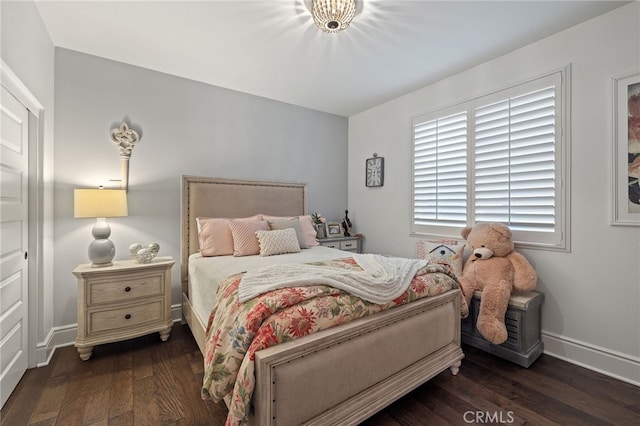 bedroom featuring baseboards and wood finished floors