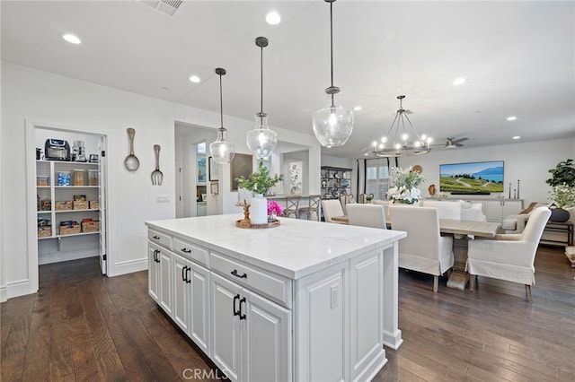 kitchen featuring dark wood finished floors, open floor plan, and a center island