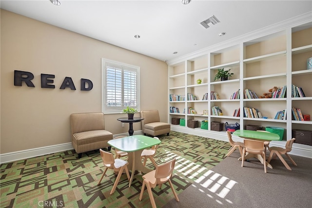 sitting room with built in shelves, baseboards, visible vents, and carpet floors