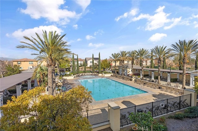 pool featuring a patio area, a residential view, and fence