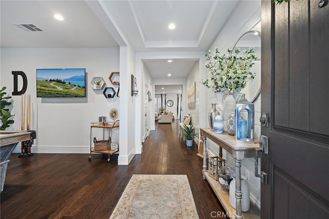 entrance foyer with visible vents, baseboards, a tray ceiling, recessed lighting, and hardwood / wood-style flooring