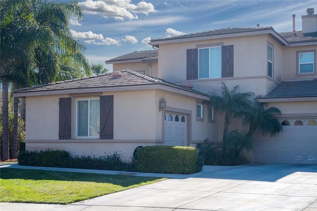 view of front facade with concrete driveway and stucco siding