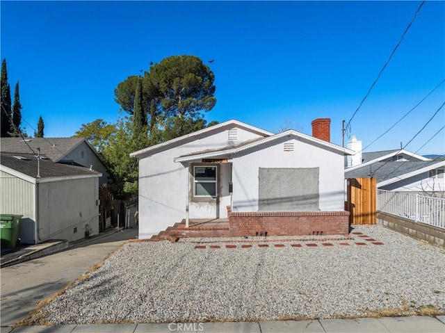 view of front of home featuring fence